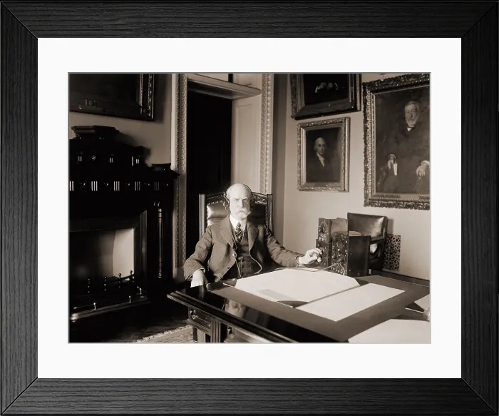 Framed Print : Charles Evans Hughes (1862-1948), Secretary of State during the Harding administration, listening to an early radio in his office. 1922