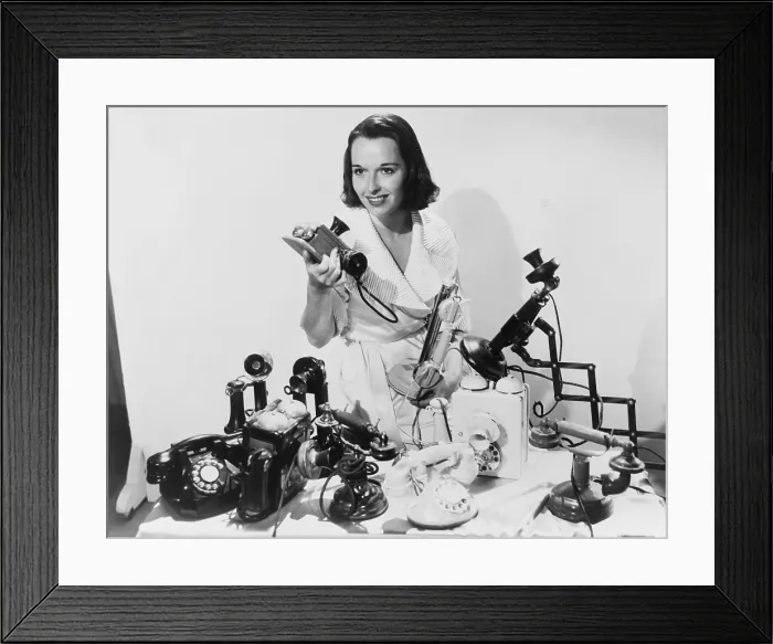 Framed Print : Louise Brooks (1906-1985), popular silent film actress, posing with ten telephones, some old models as well as the most up to date 1936 models Framed Print : Louise Brooks (1906-1985), popular silent film actress, posing with ten telephones, some old models as well as the most up to date 1936 models
