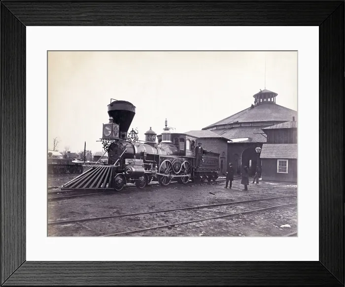 Framed Print : Engine, J.H. Devereux, of the United States Military Railroad with two crew members on board outside the roundhouse at the Alexandria station. Albumen print, photo by Andrew J Framed Print : Engine, J.H. Devereux, of the United States Military Railroad with two crew members on board outside the roundhouse at the Alexandria station. Albumen print, photo by Andrew J