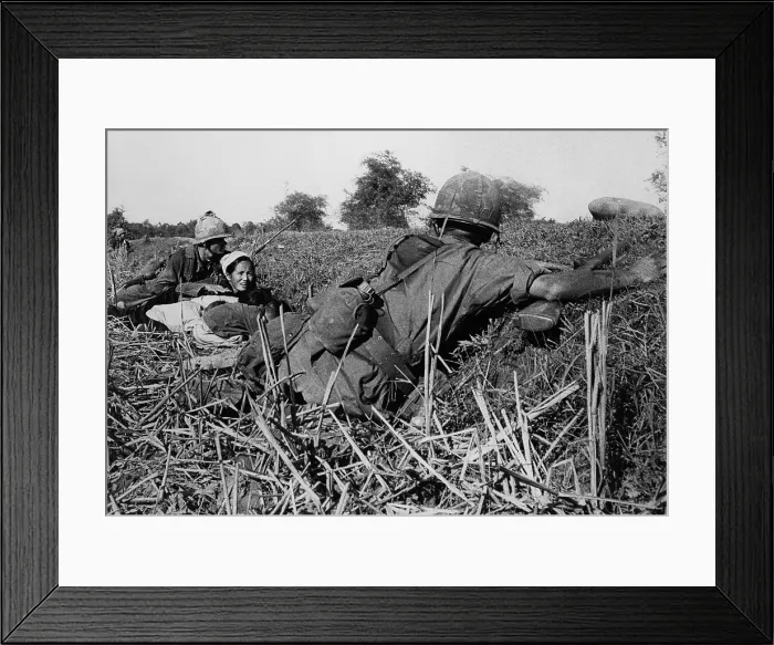 Framed Print : Vietnam War. Soldiers of the 1st Infantry Division protect a refugee mother and her children during a fight with Viet Cong