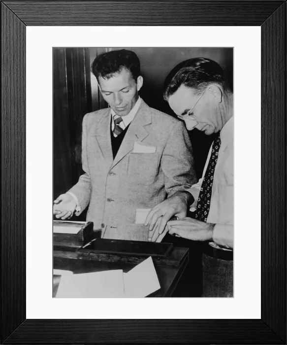 Framed Print : Frank Sinatra (1915-1998) getting fingerprints taken following application for permission to carry a gun, Hollywood, California