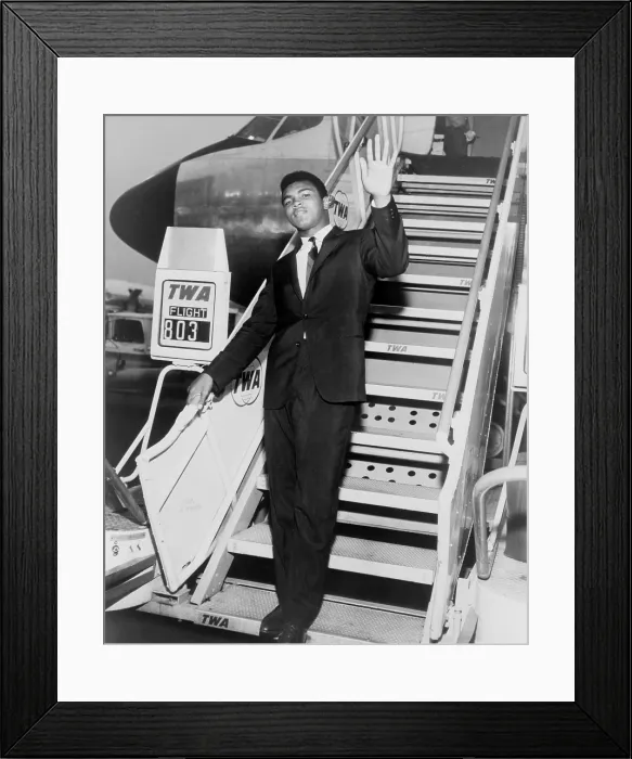 Framed Print : Muhammad Ali, waves from the steps of a TWA airplane at JFK International Airport in New York. 1964