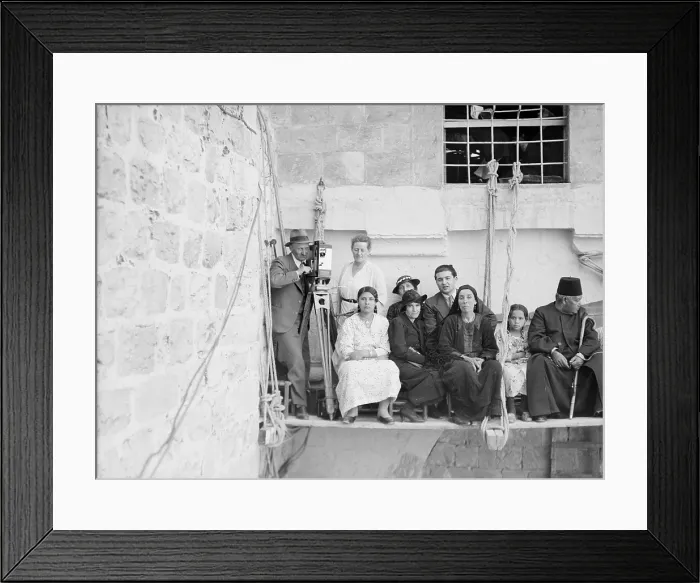 Framed Print : Man with movie camera on platform suspended from building, with other people, photograph, 1925-1946