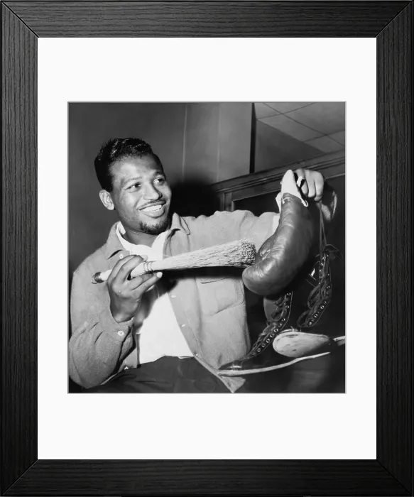 Framed Print : Sugar Ray Robinson dusting off his boxing gloves and shoes in a publicity photo for his 1954 comeback to professional boxing