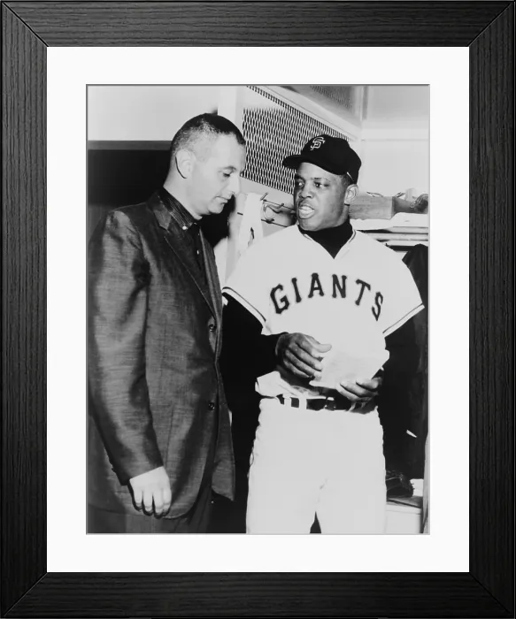 Framed Print : Willie Mays talks to sportscaster Charles Einstein in a 1963 locker room interview