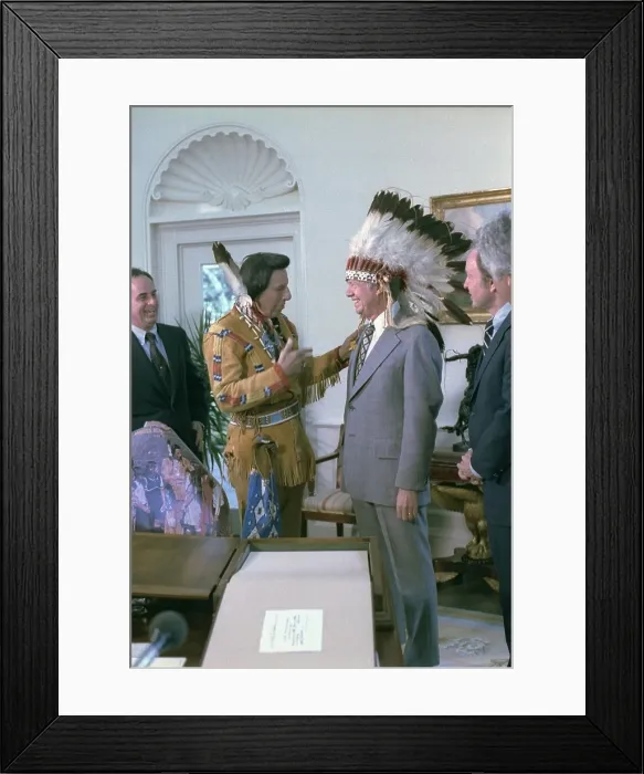 Framed Print : President Jimmy Carter wearing a feathered headdress presented to him by Iron Eyes Cody 1904-1999 an actor Framed Print : President Jimmy Carter wearing a feathered headdress presented to him by Iron Eyes Cody 1904-1999 an actor