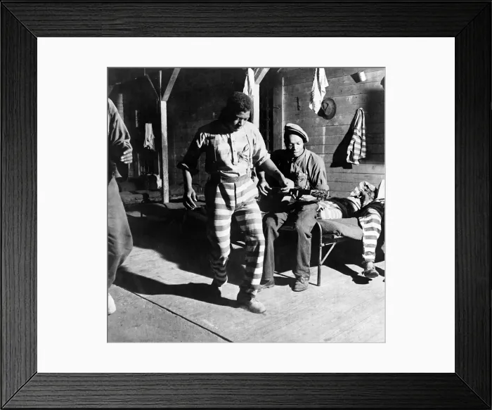 Framed Print : The Blues. A Negro convict dances while another plays the guitar at a prison camp. Greene County, Georgia. Photo by Jack Delano, 1941