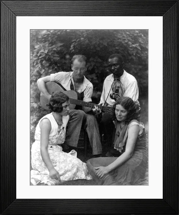 Framed Print : Folk Music. Four musicians including a man playing a guitar, a man playing a violin, and two women seated on ground, ca. 1930 Framed Print : Folk Music. Four musicians including a man playing a guitar, a man playing a violin, and two women seated on ground, ca. 1930
