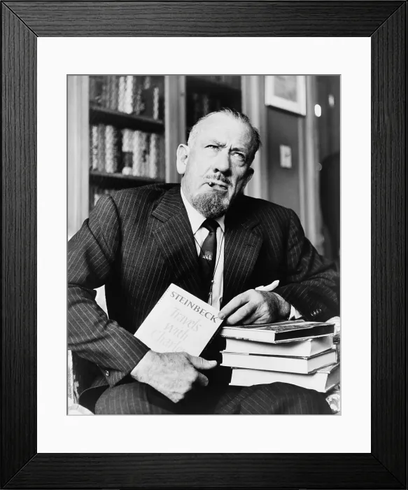 Framed Print : John Steinbeck (1902-1968), American author who received the Nobel Prize in 1962, holds his most recent book 'Travels with Charley.' 1962