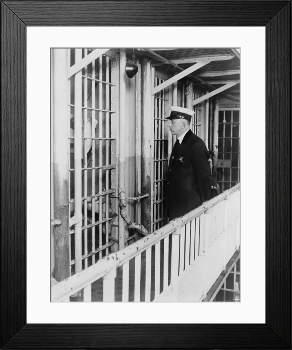 Framed Print : A prison guard at the Cook County jail standing outside the cell of confessed thrill murder Nathan Leopold, Jr. in 1924