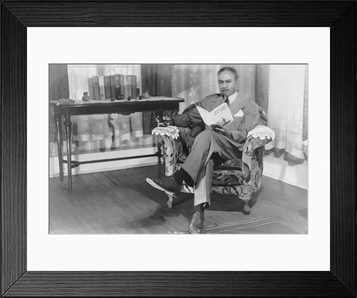 Framed Print : Melvin Beaunorus Tolson (1898-1966) African American author and poet, reading a copy of his book, Rendezvous with America. 1946