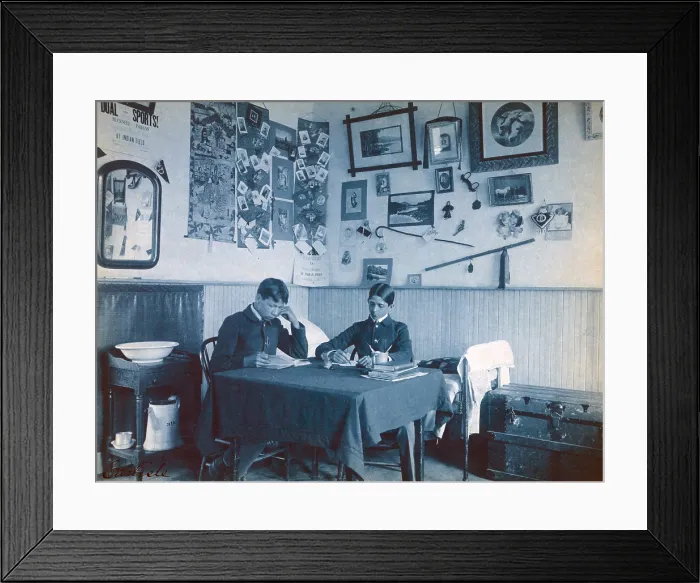 Framed Print : Carlisle Indian School, Carlisle, Pa. Two Native Americans boys studying in dormitory room. Cyanotype by Frances Benjamin Johnston ca. 1901