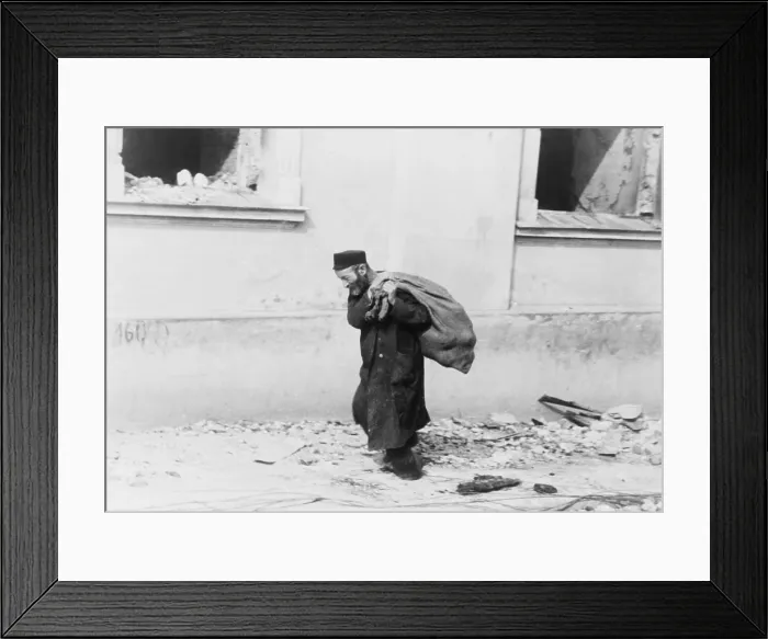 Framed Print : A solitary Jewish man carrying a sack walking past bomb damaged buildings in Poland in the early days of World War II. 1939-40 Framed Print : A solitary Jewish man carrying a sack walking past bomb damaged buildings in Poland in the early days of World War II. 1939-40