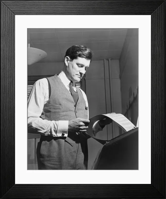 Framed Print : Eric Sevareid (1912-1992), reads document from teletype. He was one of the Murrow boys, the first generation of CBS broadcast journalists mentored by Edward R. Murrow