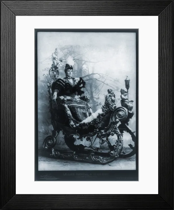 Framed Print : Lillian Russell (1861-1922), American actress, seated in ornate sleigh, in THE GRAND DUTCHESS. 1894 Framed Print : Lillian Russell (1861-1922), American actress, seated in ornate sleigh, in THE GRAND DUTCHESS. 1894