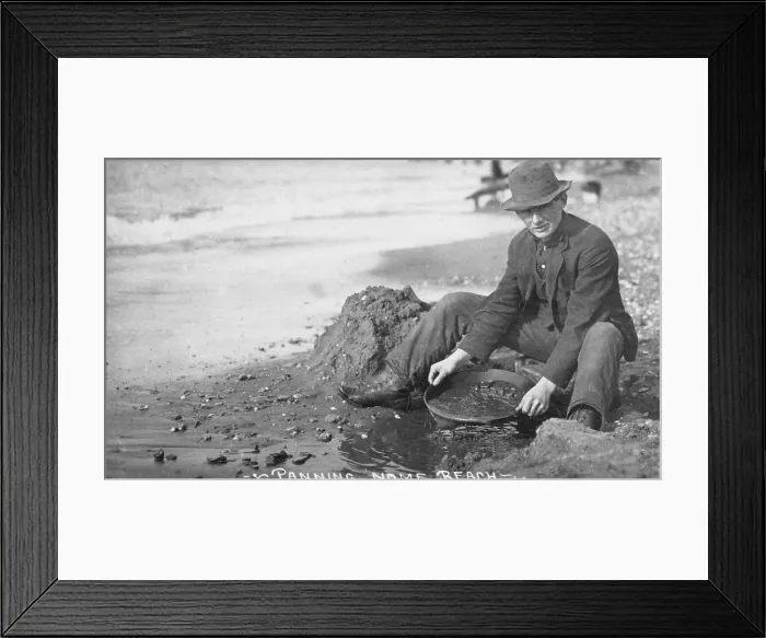 Framed Print : Man panning gold on Nome, Alaska beach in the early 20th century