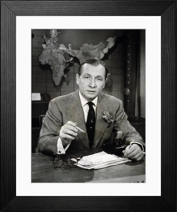 Framed Print : John Cameron Swayze (1906-1966), at news anchor desk, used his acting experience to visually enliven news reporting for television. 1955