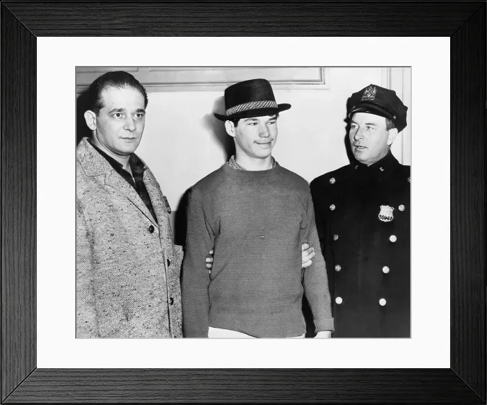 Framed Print : Carl Cintron, Mau Maus gang member, grinning as he was booked in the fatal shooting of a rival gang member, Anthony Labanchino, in downtown Brooklyn. February 1959