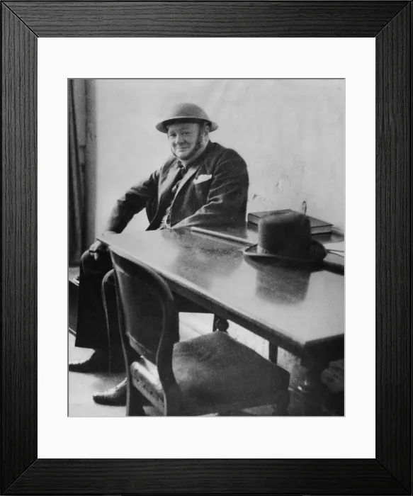 Framed Print : Winston Churchill (1874-1965), wearing a steel helmet during his visit to Dover and Ramsgate air raid damaged areas in September 1940. His derby hat sits on the table