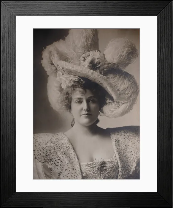 Framed Print : Actress Lillian Russell wears an ostrich feather hat and embroidered and jeweled dress, c. 1890s