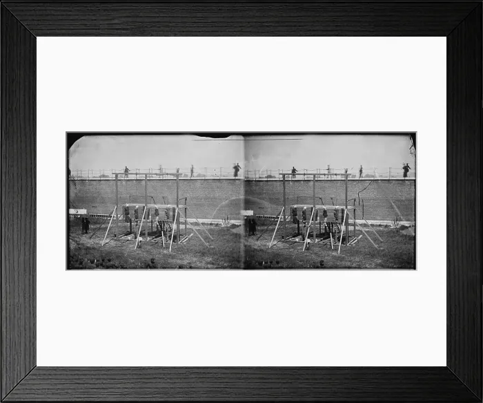 Framed Print : The assassination of President Abraham Lincoln, hanging hooded bodies of the four conspirators, guards only in yard, Washington DC, stereo photograph by Alexander Gardner, July 7