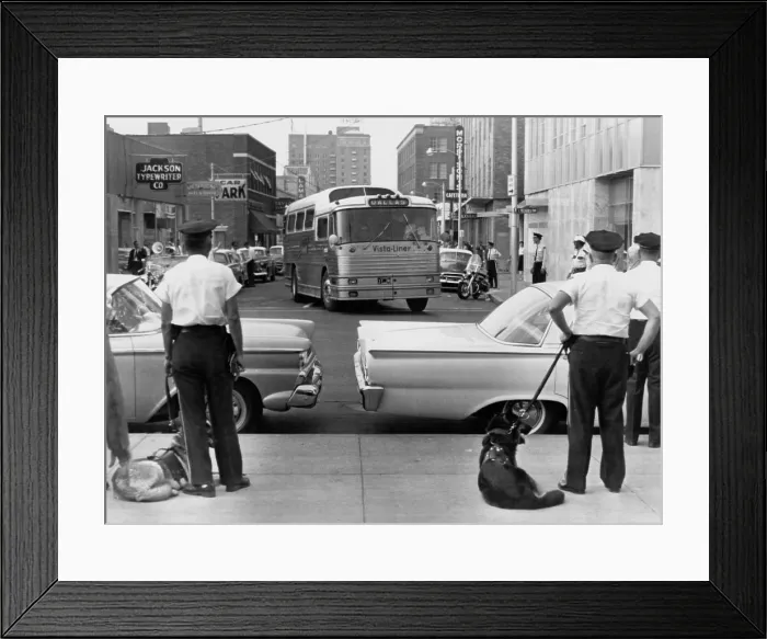 Framed Print : Policemen watch as Freedom Riders arrive in Jackson, Mississippi on a Trailways bus. May 24, 1961