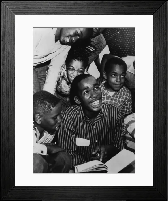Framed Print : Ernest Green, one of the Little Rock Nine, shows his new textbook to his friends, after his first full day at Little Rock Central High School