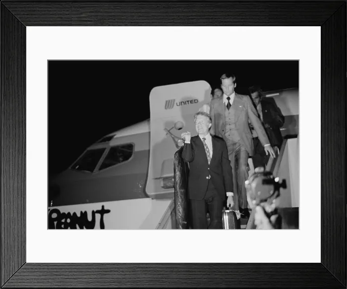 Framed Print : Presidential candidate Jimmy Carter carrying his own luggage as he disembarks from the airplane Peanut One at the Wilkes-Barre Scranton Airport for a campaign stop