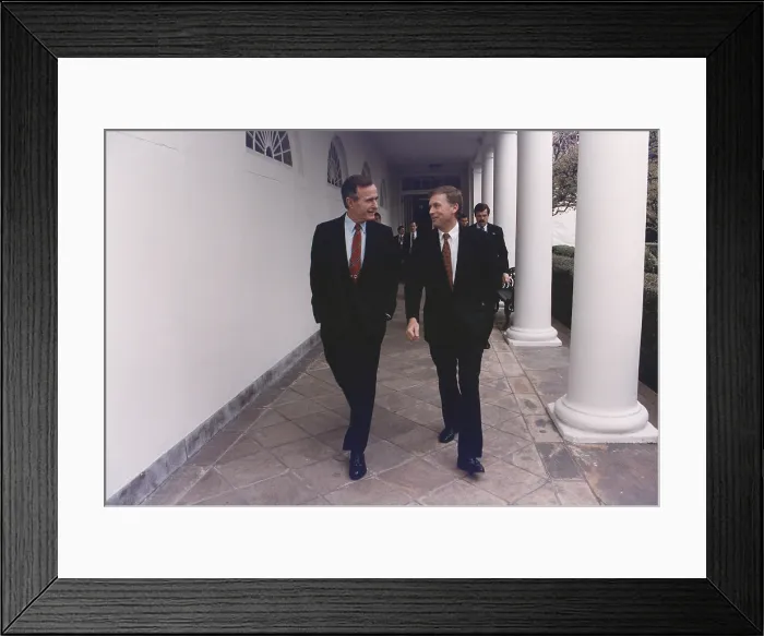 Framed Print : President George H.W. Bush walks along the West Wing colonnade with his Vice-President Dan Quayle. Ca. 1990