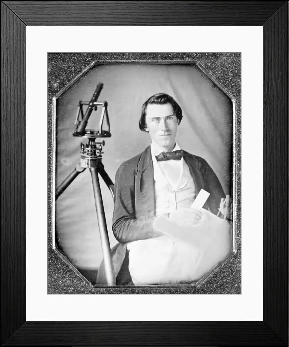 Framed Print : Occupational portrait of an unidentified surveyor with a transit on a tripod and holding dividers and a map. sixth plate daguerreotype, ca. 1840-1860