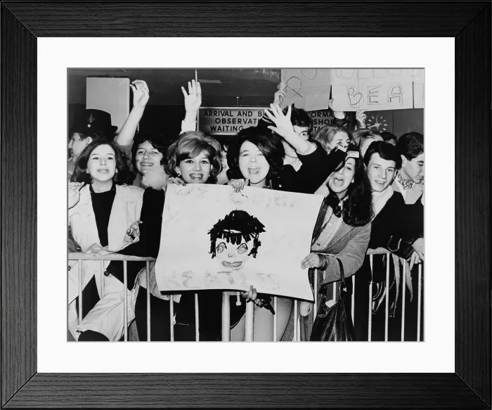 Framed Print : Screaming teenagers girls wave a crude sign as they welcome The Beatles at New York's Kennedy Airport. Feb. 7, 1964 Framed Print : Screaming teenagers girls wave a crude sign as they welcome The Beatles at New York's Kennedy Airport. Feb. 7, 1964