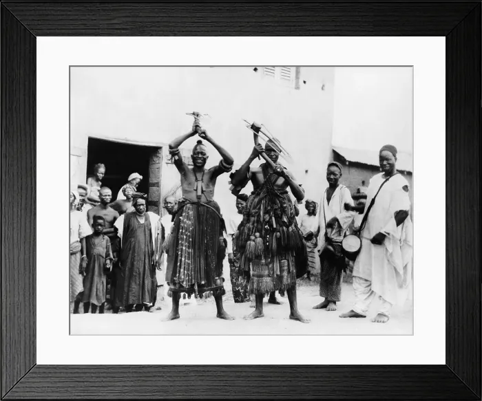 Framed Print : Two itinerant medicine men on a street in the village of Abeokuta, Southern Nigeria. Performing a hoe dance a traditional Hausa agricultural dance. Ca. 1935 Framed Print : Two itinerant medicine men on a street in the village of Abeokuta, Southern Nigeria. Performing a hoe dance a traditional Hausa agricultural dance. Ca. 1935