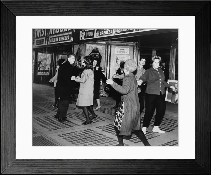 Framed Print : Teens dancing the Twist outside the Brooklyn Fox Theatre before the premiere of the movie Twist Around the Clock'. 1961