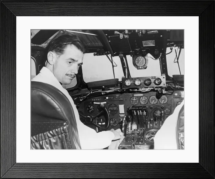 Framed Print : Howard Hughes seated in the cockpit TWA Constellation to demonstrate a new radar terrain clearance warning system that sounds a horn when the plane comes within 2000 feet of any Framed Print : Howard Hughes seated in the cockpit TWA Constellation to demonstrate a new radar terrain clearance warning system that sounds a horn when the plane comes within 2000 feet of any