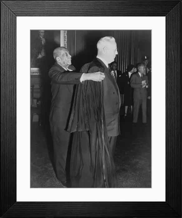 Framed Print : Supreme Court Chief Justice Earl Warren, being helped into his judicial robes by R.G. Marshall in 1953