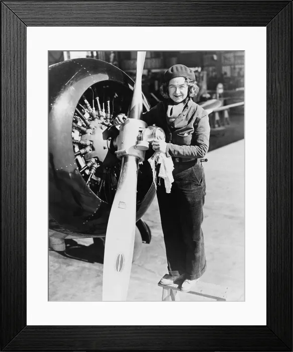 Framed Print : Laura Ingalls (1901-1967), American female aviator atop ladder maintaining an airplane propeller