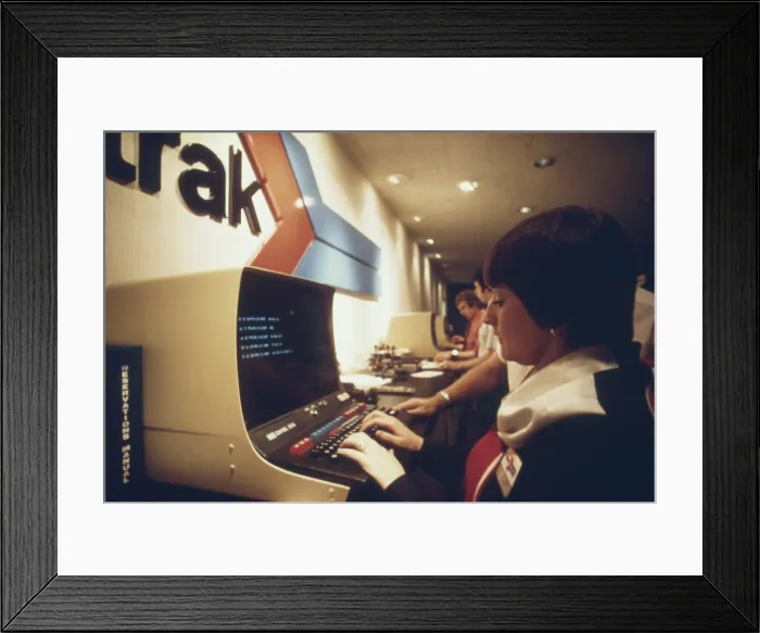 Framed Print : An AMTRAK worker at a computer terminal gets information on available space and fares and can enter reservations