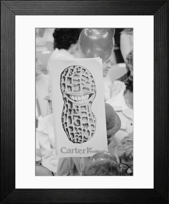 Framed Print : Jimmy Carter supporter holding Carter for President sign showing a peanut shell with a toothy grin at the Democratic National Convention New York City. July 14 1976 Framed Print : Jimmy Carter supporter holding Carter for President sign showing a peanut shell with a toothy grin at the Democratic National Convention New York City. July 14 1976