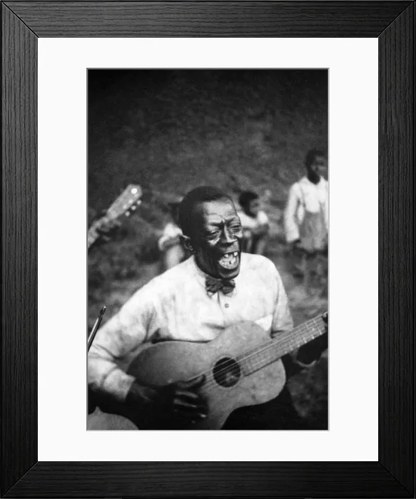 Framed Print : Stavin Chain (Wilson Jones), Blue Singer, playing guitar and singing the ballad 'Batson, ' Lafayette, Louisiana. 1934