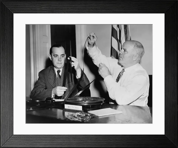 Framed Print : J. Parnell Thomas, chairman of House Un-American Activities Committee, (right), examine films while investigating the communist infiltration in Hollywood. 1947