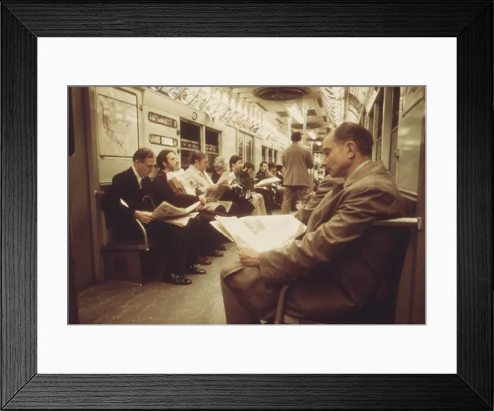 Framed Print : New York City Subway. Passengers with their newspapers on the New York City Subway. May 1973