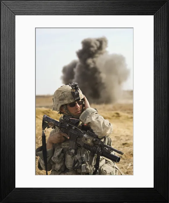 Framed Print : U.S. Army soldier with covers his ear as a controlled detonation destroys an improvised explosive device in Badula Qulp Afghanistan on Feb