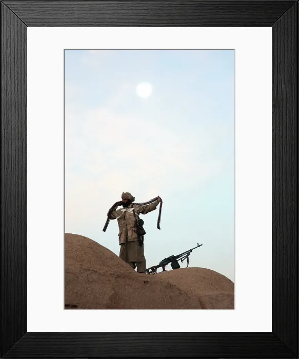Framed Print : An Anti-Taliban fighter wraps a bandolier of Kalashnikov machine gun ammunition around his body. Helmand Province Jan.1 2002. Photo by:Everett Collection(BSLOC_2011_6_78) Framed Print : An Anti-Taliban fighter wraps a bandolier of Kalashnikov machine gun ammunition around his body. Helmand Province Jan.1 2002. Photo by:Everett Collection(BSLOC_2011_6_78)