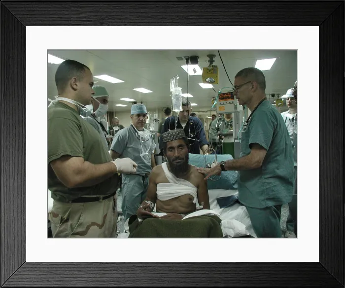 Framed Print : Medical personnel of USS Bataan treat wounded Pashtun soldier from Afghanistan Dec. 6 2001. Photo by:Everett Collection(BSLOC_2011_6_81)