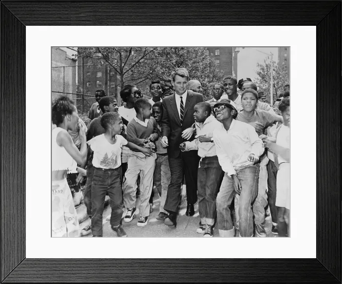 Framed Print : Attorney General Robert Kennedy surrounded by African American children. He was visiting a summer reading program in Harlem at the Morningside Community Center, in Manhattan. Aug