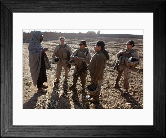 Framed Print : U.S. Marines in Afghanistan assigned to a female engagement team speak with a local Afghan man in his compound during a patrol in Marjah Helmand province Afghanistan. Dec
