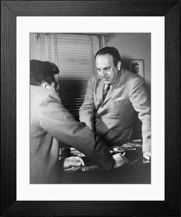 Framed Print : Director Robert Wise (1914-2005) and producer Val Lewton (left) conversing across a desk. Lewton was head of the B-horror unit at RKO Pictures. Ca. 1942