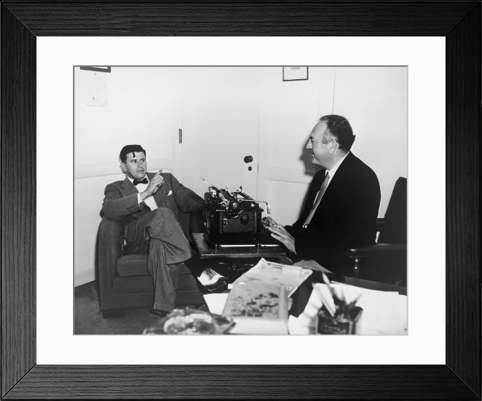 Framed Print : Film producer Val Lewton (1904-1951), in a meeting with a nattily-dressed man wearing a bow tie and spectator shoes. Ca. 1945 Framed Print : Film producer Val Lewton (1904-1951), in a meeting with a nattily-dressed man wearing a bow tie and spectator shoes. Ca. 1945