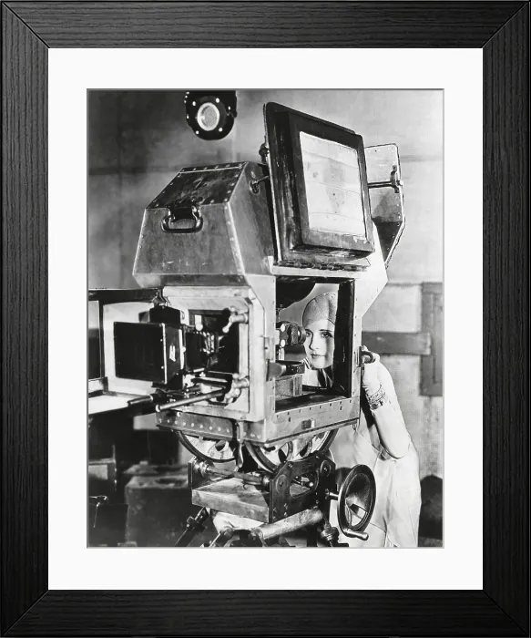 Framed Print : Actress Norma Shearer inspects a sound proof camera. It eliminated the need of the unwieldy booths and permitted the same sweep of the camera action as in silent pictures. Aug
