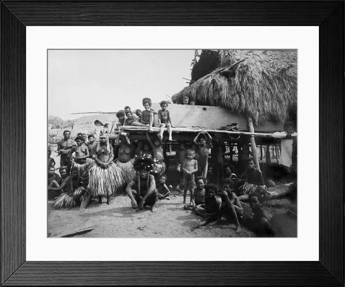 Framed Print : Group of Tongans in traditional costume pose in front of village buildings in 1919. Tonga was a British protectorate from 1900-1970 Framed Print : Group of Tongans in traditional costume pose in front of village buildings in 1919. Tonga was a British protectorate from 1900-1970
